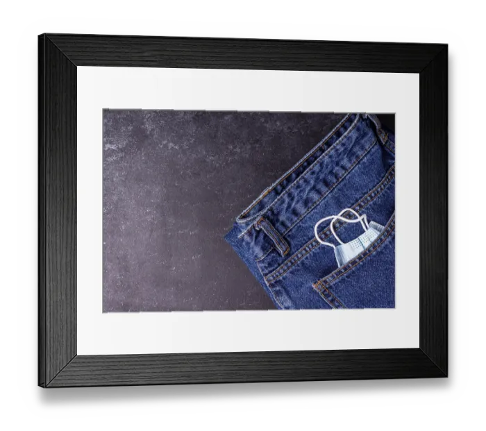 Framed Print : A medical mask peeks out of a jeans pocket