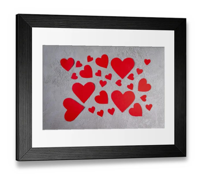 Framed Print : Red paper hearts scattered over gray plaster