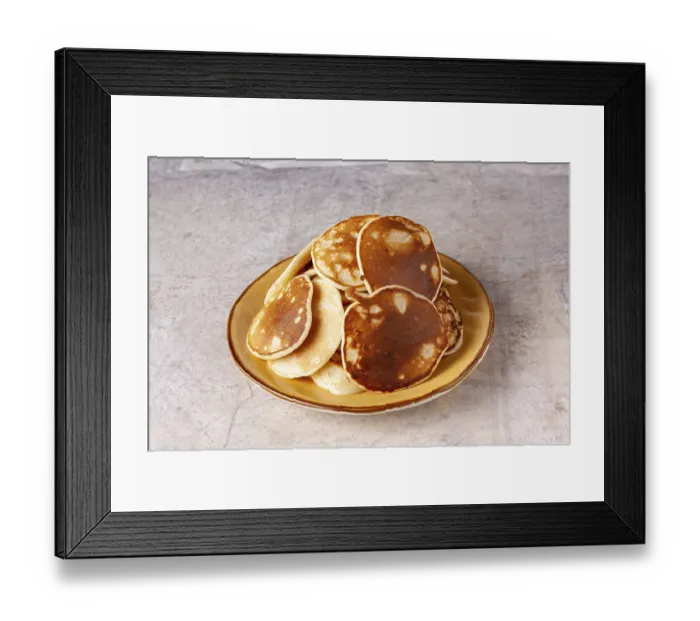 Framed Print : A pile of pancakes lies in a yellow clay plate close-up