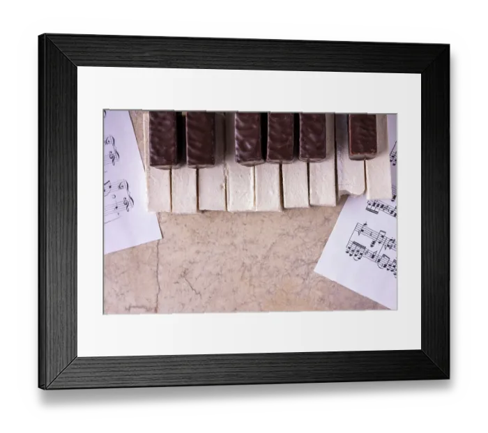 Framed Print : Piano lined with bitten off marshmallows on a beige background