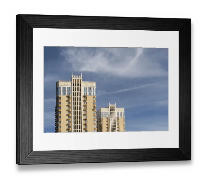 Framed Print : Two modern multi-storey buildings rise against the sky