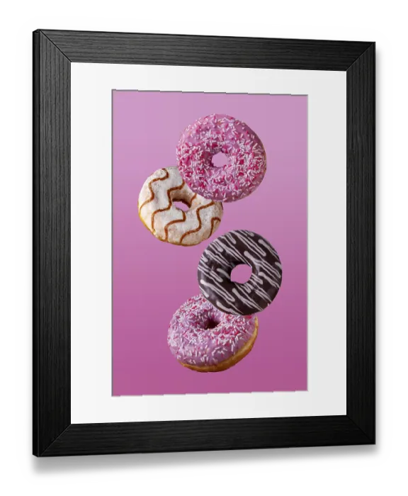 Framed Print : Donuts in chocolate and in sugar glaze fly on a pink background