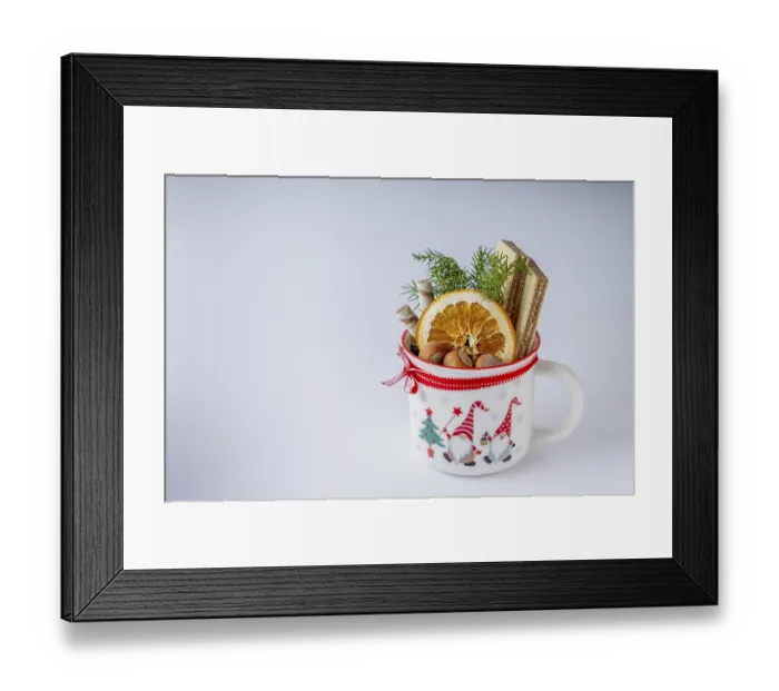 Framed Print : A mug with dry orange, nuts, waffles