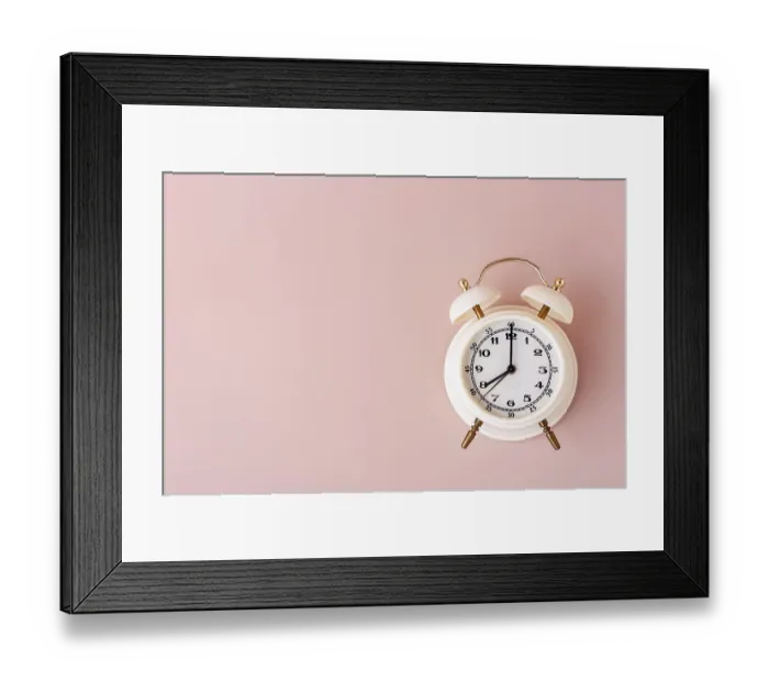 Framed Print : White alarm clock on pink background place text