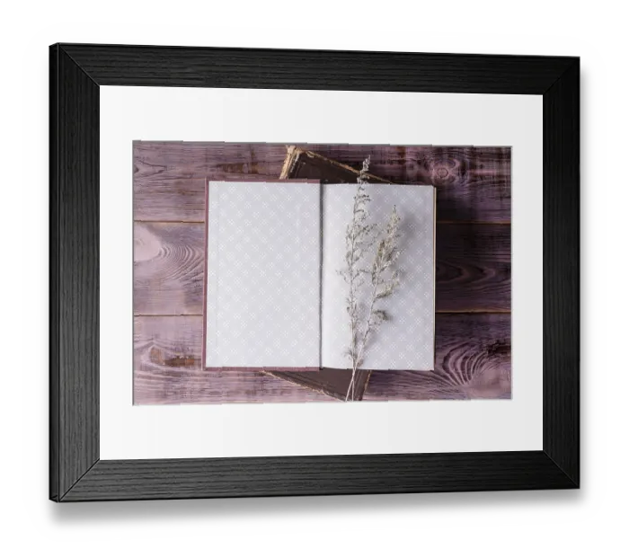 Framed Print : Open book wormwood branch on wooden background