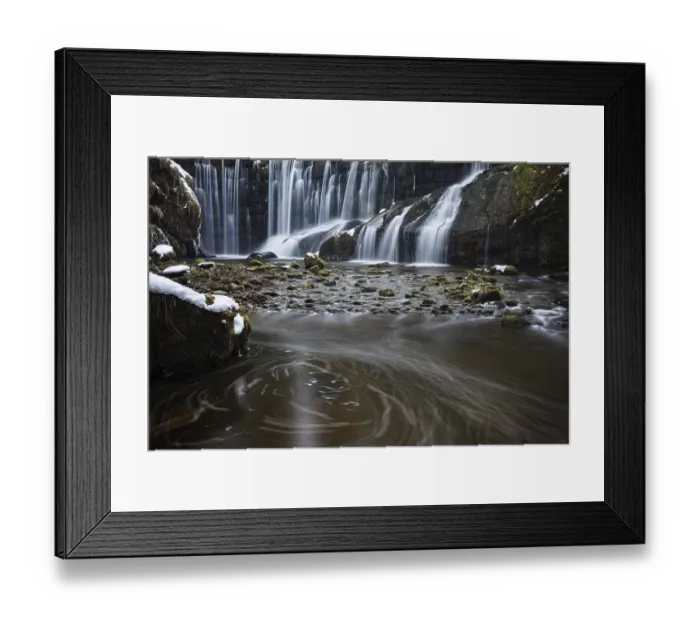 Framed Print : Steady waterfall flows over moss-covered stones in a calm river
