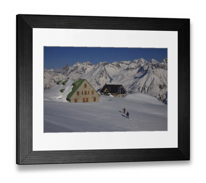 Framed Print : Snow-covered mountain huts with ski tourers in front of the impressive mountain panorama of the Allgau main ridge