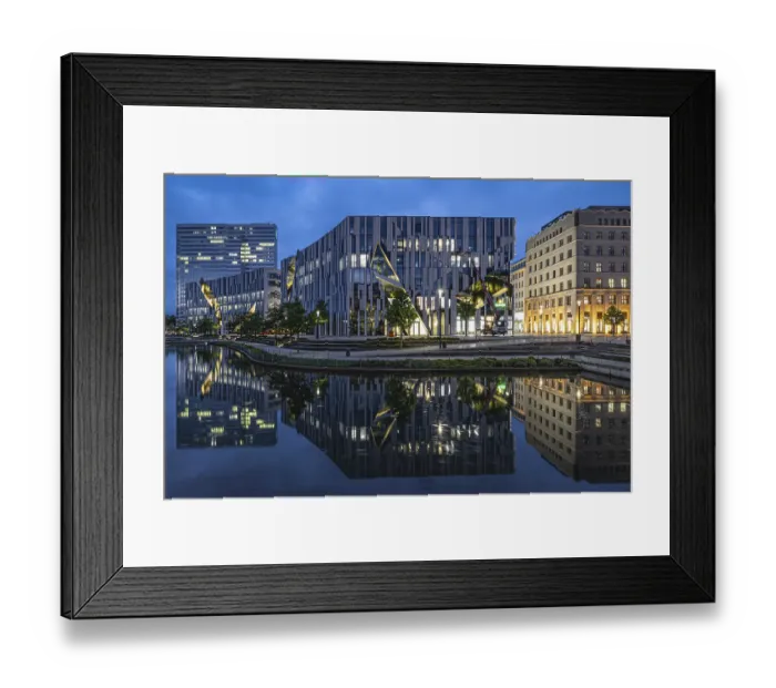 Framed Print : Modern buildings reflected in the water under a blue evening sky Framed Print : Modern buildings reflected in the water under a blue evening sky