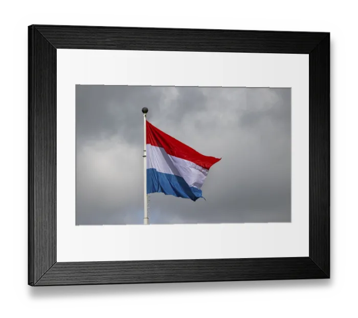 Framed Print : Luxembourg flag waving against a cloudy sky