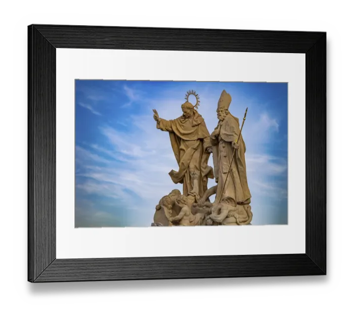 Framed Print : Sculpture of saints under a blue sky