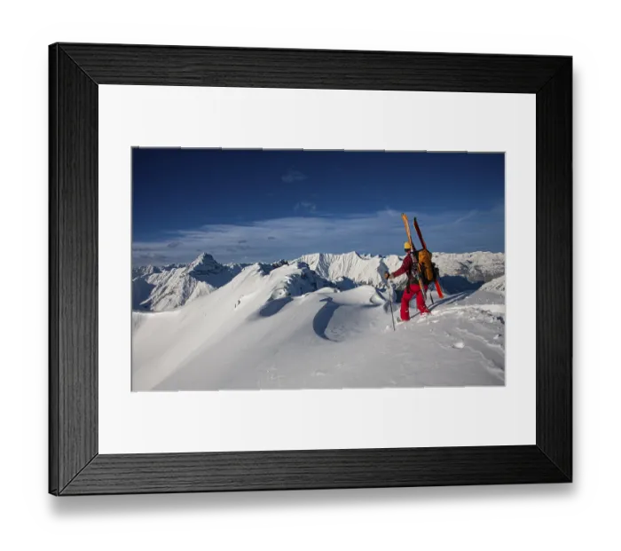 Framed Print : A ski tourer with skis on his rucksack Framed Print : A ski tourer with skis on his rucksack