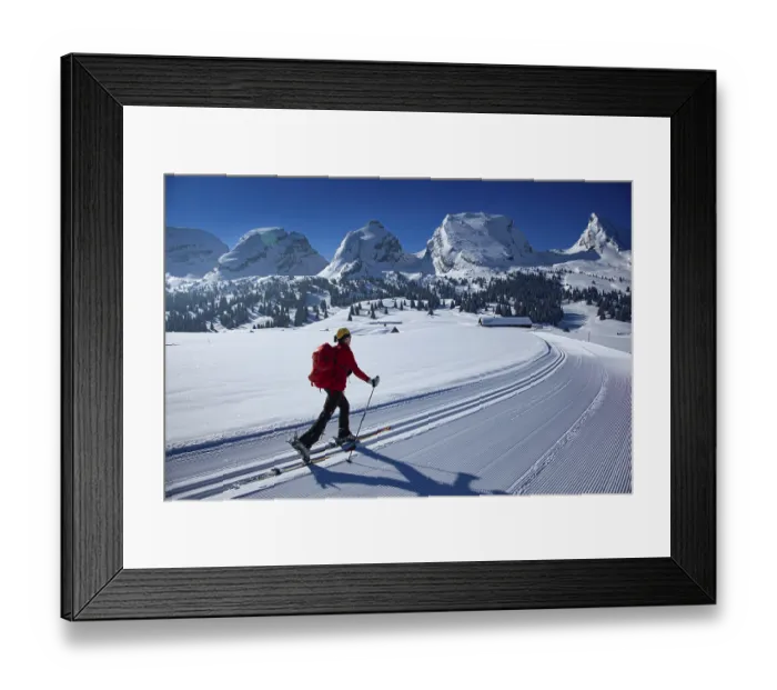 Framed Print : Ski tourer in a cross-country ski track climbing towards the Churfirsten under a clear blue sky Framed Print : Ski tourer in a cross-country ski track climbing towards the Churfirsten under a clear blue sky