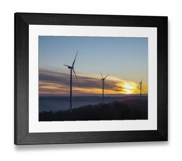 Framed Print : Three wind turbines at sunrise over fog-covered forests