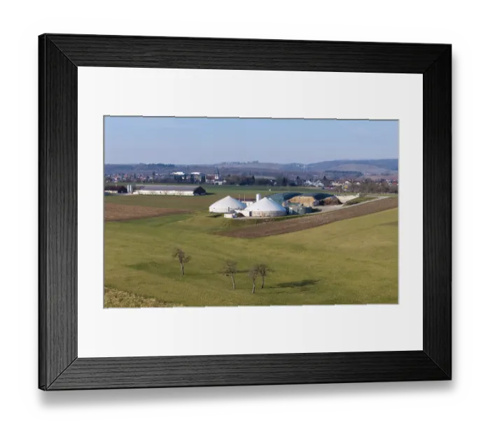 Framed Print : Rural scene with biogas plant, few trees and village