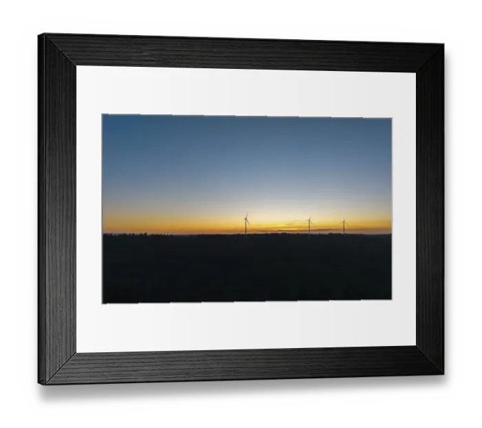 Framed Print : Silhouette of wind turbines in front of a colourful sunset sky Framed Print : Silhouette of wind turbines in front of a colourful sunset sky