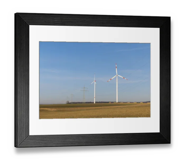 Framed Print : Landscape with wind turbines and power lines in front of a blue sky
