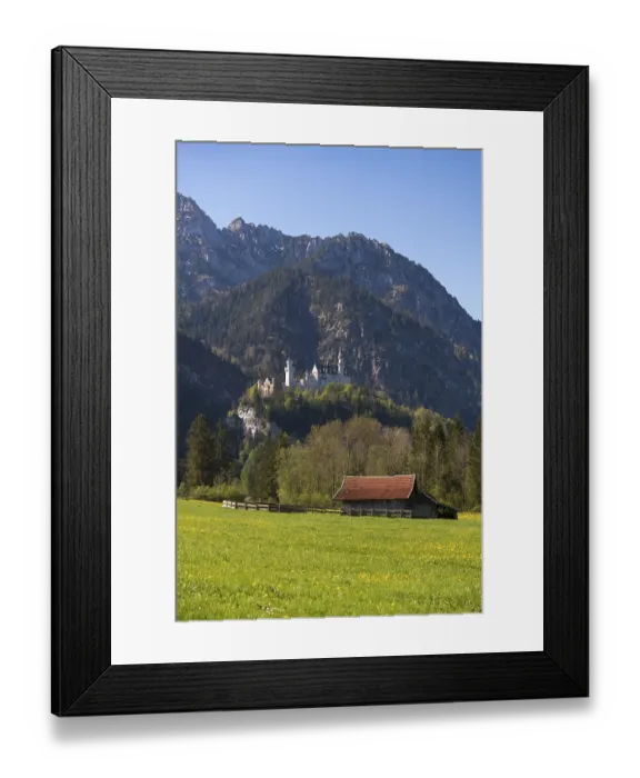 Framed Print : A small hut on a wide meadow with a castle majestically perched on a mountain peak behind it Framed Print : A small hut on a wide meadow with a castle majestically perched on a mountain peak behind it