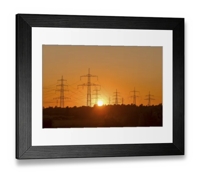 Framed Print : Electricity pylons in front of a glowing sunset on the horizon Framed Print : Electricity pylons in front of a glowing sunset on the horizon
