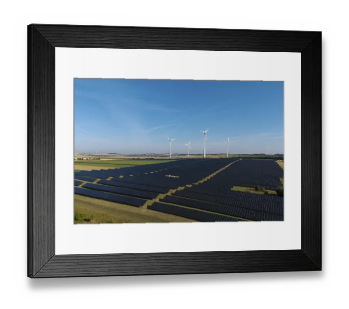 Framed Print : Extensive field with solar cells and wind turbines in rural area