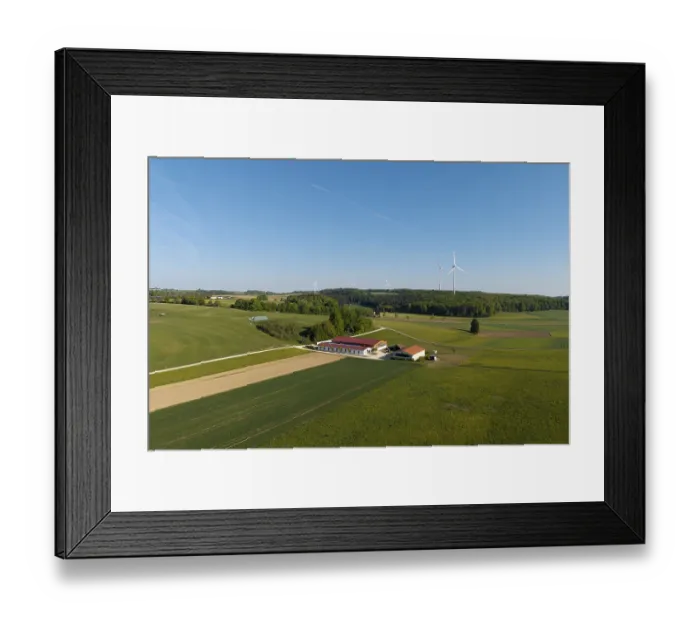 Framed Print : An expansive field landscape with a farm and wind turbines Framed Print : An expansive field landscape with a farm and wind turbines