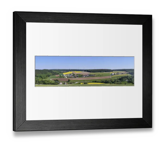 Framed Print : Panorama of a rural landscape with fields and wind turbines under a blue sky