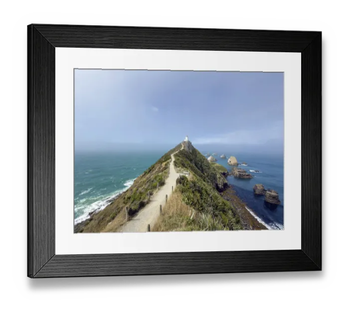 Framed Print : Nugget Point Lighthouse with Nugget Rocks in front of a blue sky Framed Print : Nugget Point Lighthouse with Nugget Rocks in front of a blue sky