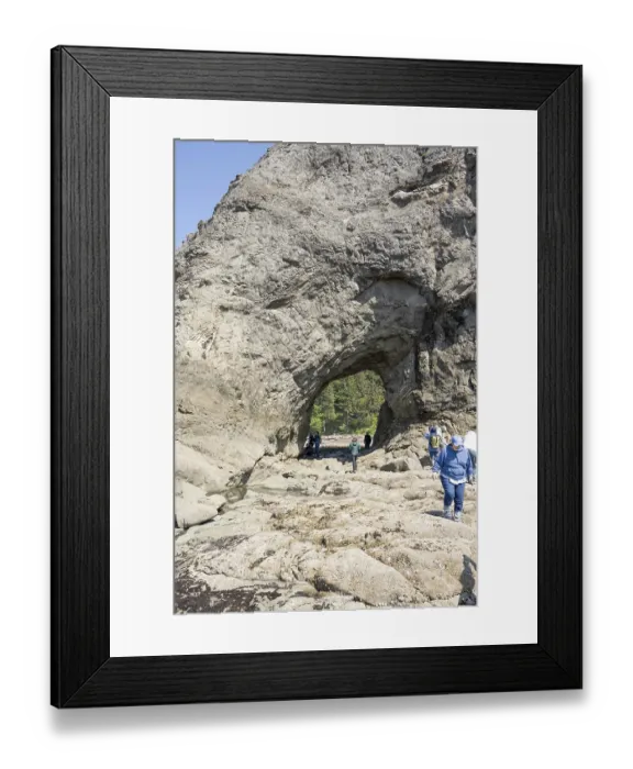 Framed Print : Large rock with a hole and people in the foreground