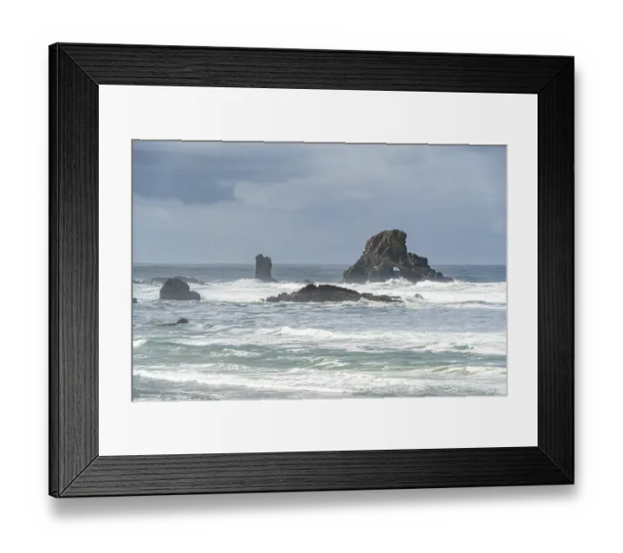 Framed Print : A rugged coastal landscape with rocks in the sea and a cloudy sky Framed Print : A rugged coastal landscape with rocks in the sea and a cloudy sky