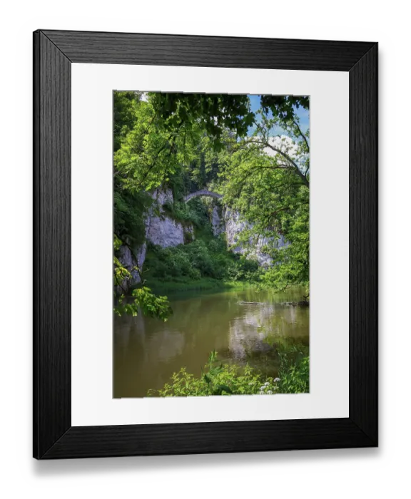 Framed Print : The Stone Devil's Bridge on the Klosterfelsenweg in Inzigkofen spans a river amidst dense green vegetation