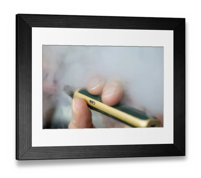 Framed Print : Man vaping an e-cigarette