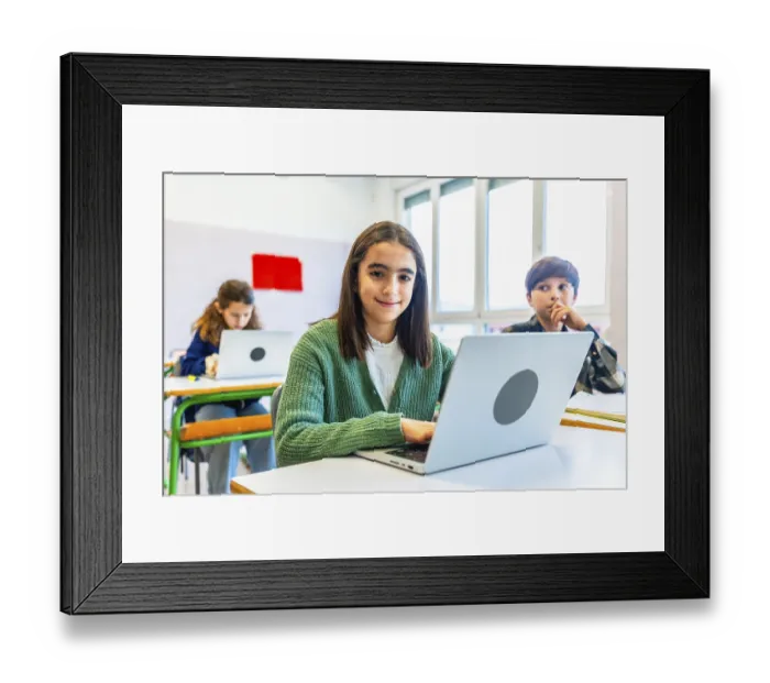 Framed Print : Elementary school student using laptop during class Framed Print : Elementary school student using laptop during class