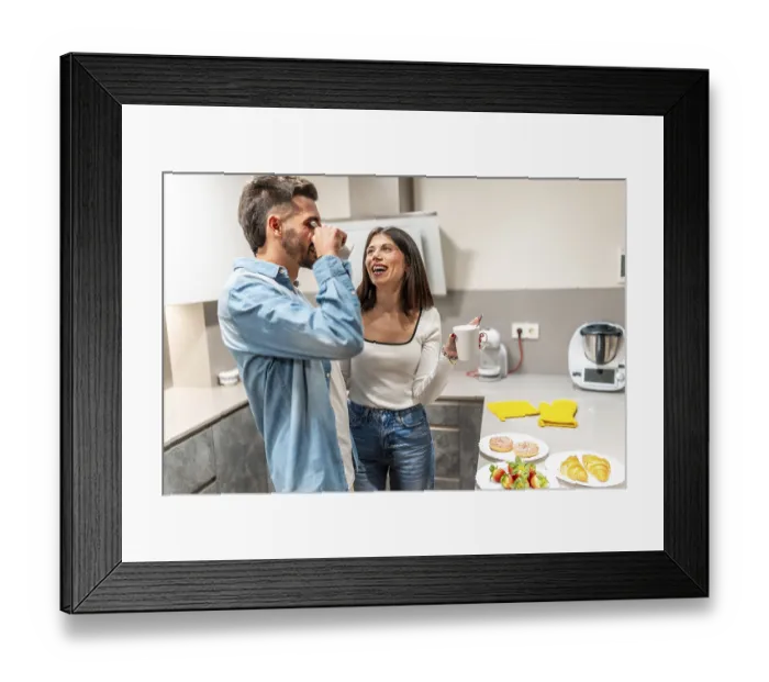 Framed Print : Happy couple drinking coffee and laughing together while having breakfast in their modern kitchen Framed Print : Happy couple drinking coffee and laughing together while having breakfast in their modern kitchen