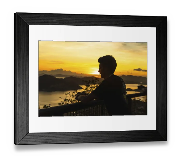 Framed Print : Silhouette of a tourist leaning on a railing