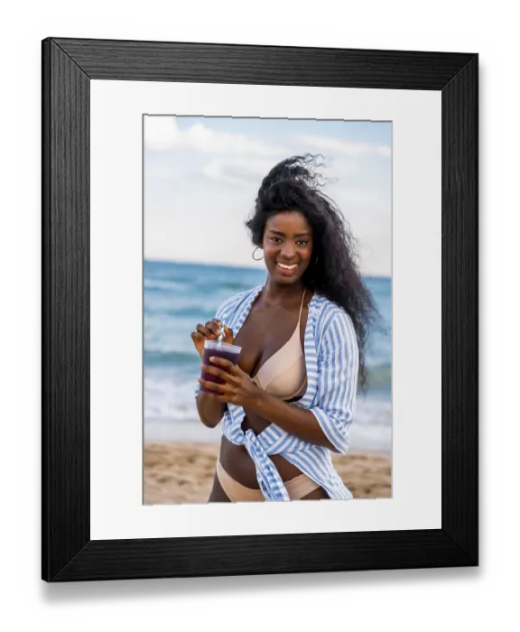 Framed Print : Young woman smiling and sipping a refreshing drink on a sunny beach