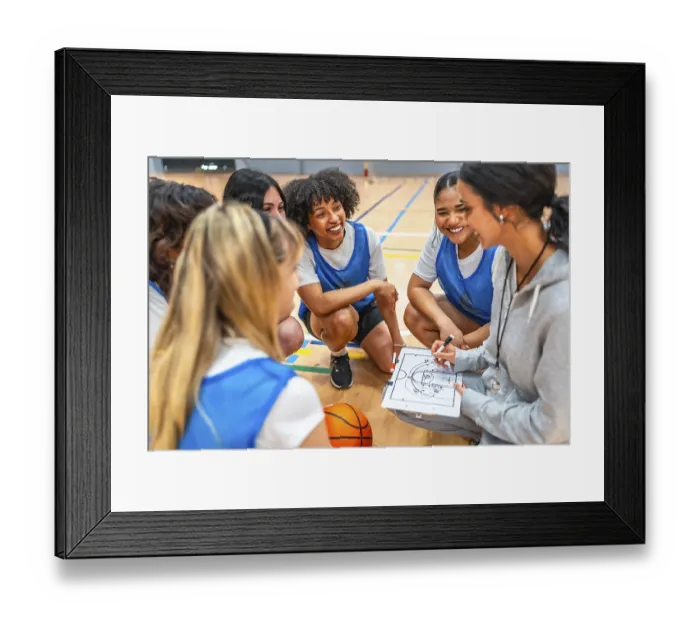 Framed Print : Female basketball coach drawing a play on a clipboard while explaining game strategy to her team during a time out Framed Print : Female basketball coach drawing a play on a clipboard while explaining game strategy to her team during a time out