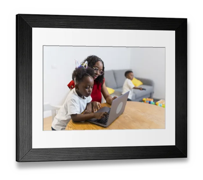Framed Print : Mother and daughter using laptop computer at home