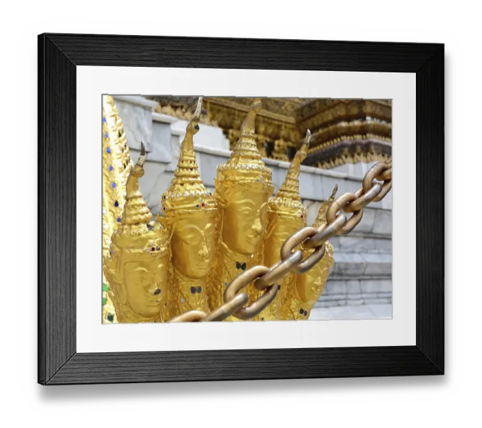 Framed Print : Golden garuda statues adorned with intricate metal chains stand prominently in the foreground