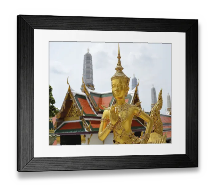 Framed Print : Golden kinnara statue praying with hands joined in a traditional thai greeting