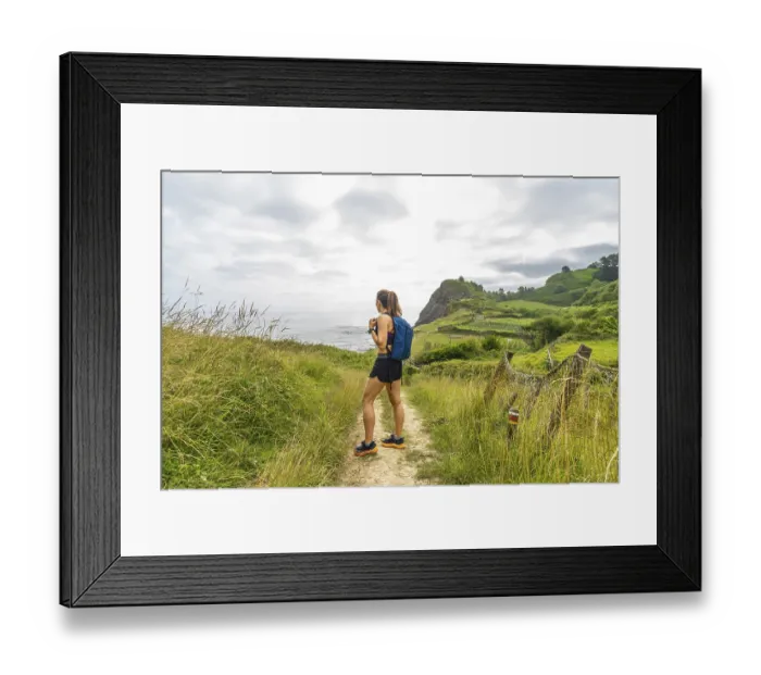 Framed Print : Female hiker enjoying the scenic view of sakoneta beach and its flysch cliffs in zumaia