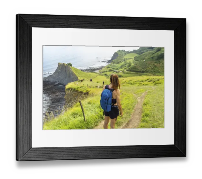Framed Print : Female hiker admiring the view of sakoneta beach and its coastal flysch in zumaia Framed Print : Female hiker admiring the view of sakoneta beach and its coastal flysch in zumaia