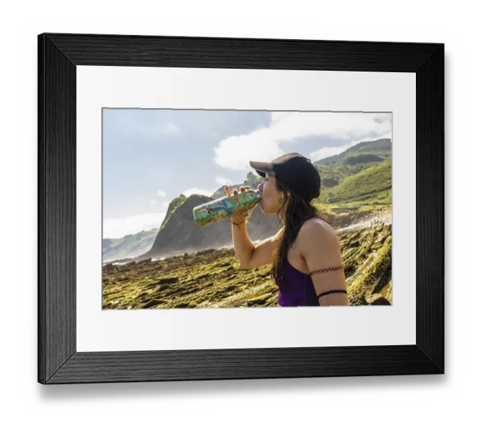 Framed Print : Female athlete hydrating after exercising on sakoneta beach