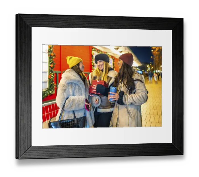Framed Print : Three cheerful women holding christmas gifts and hot drinks