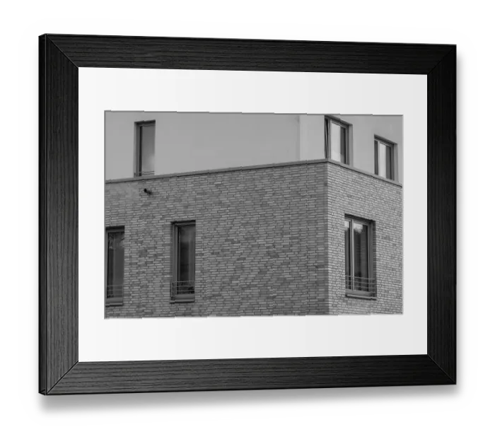 Framed Print : Architectural detail of a modern brick building showing windows and a drainpipe