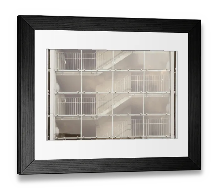 Framed Print : Glass facade of a modern building revealing staircases with metal railings