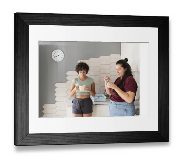 Framed Print : A loving lesbian couple enjoys a morning coffee together in their modern kitchen Framed Print : A loving lesbian couple enjoys a morning coffee together in their modern kitchen