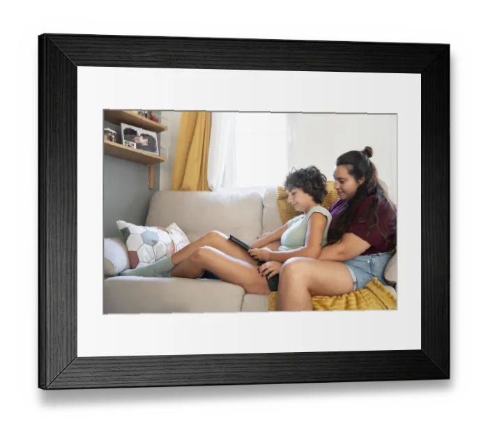Framed Print : A loving lesbian couple sitting together on a cozy sofa Framed Print : A loving lesbian couple sitting together on a cozy sofa