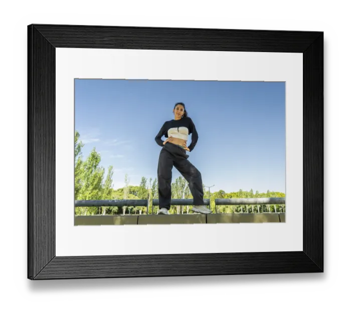 Framed Print : Confident urban dancer striking a pose in a sunny park Framed Print : Confident urban dancer striking a pose in a sunny park