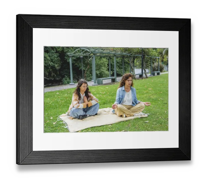 Framed Print : Two women practicing mindfulness and meditation on grass
