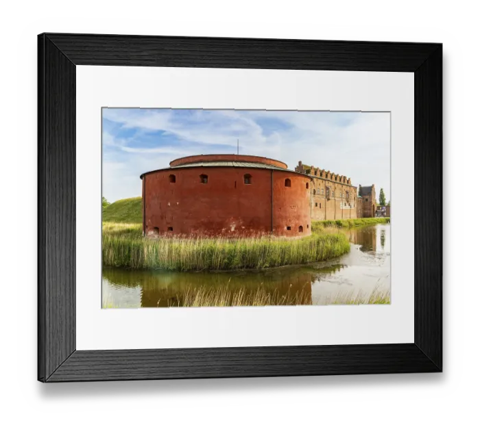 Framed Print : Impressive round tower of historic Malmohus Castle surrounded by water