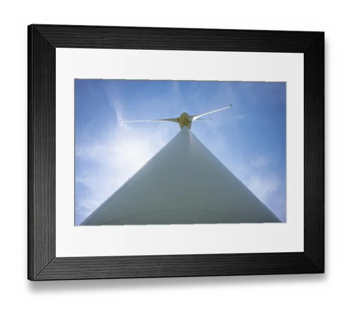Framed Print : Wind Turbine with Sunlight and Against Blue Sky and Clouds in a Sunny Summer Day in Andermatt